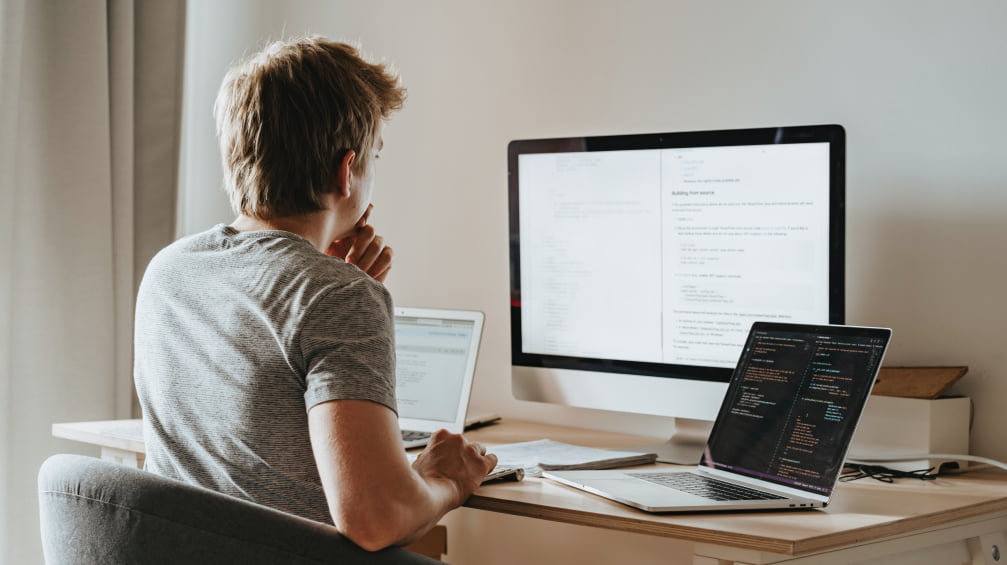 Person thinking in front of a computer