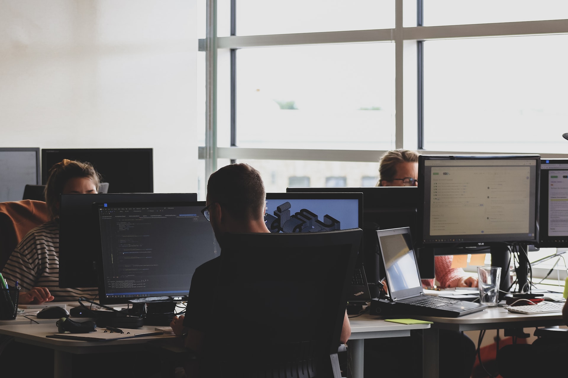 Programmers working at their computer workstations.