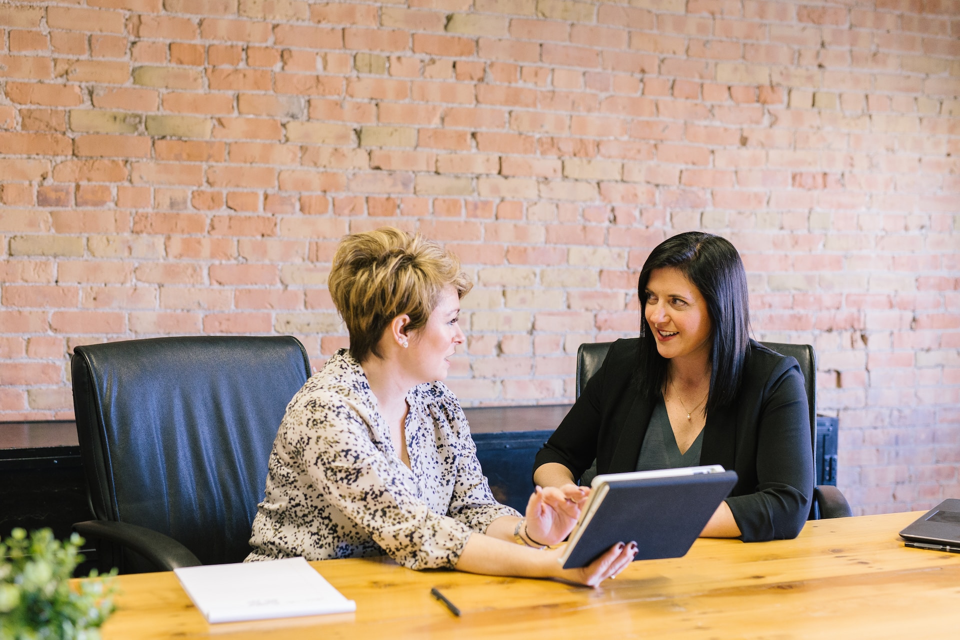 Two women having a meeting to discuss a software development project.